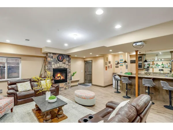 a living room with lots of furniture and view of kitchen