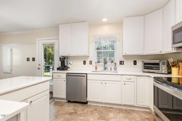a kitchen with a sink stainless steel appliances and cabinets