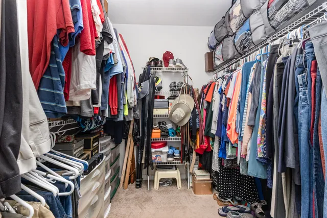 a bedroom with furniture and a book shelf