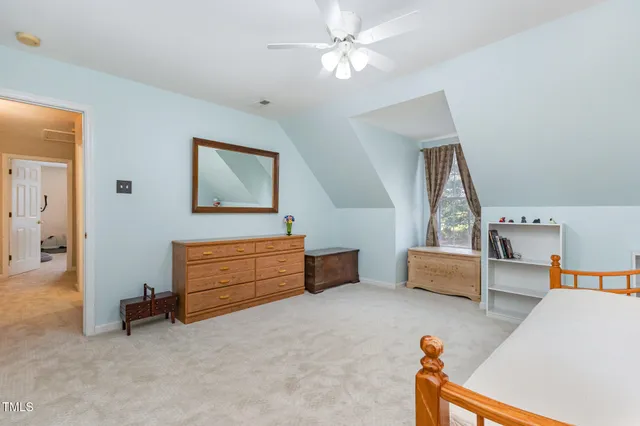 a bathroom with a granite countertop shower a toilet and a window