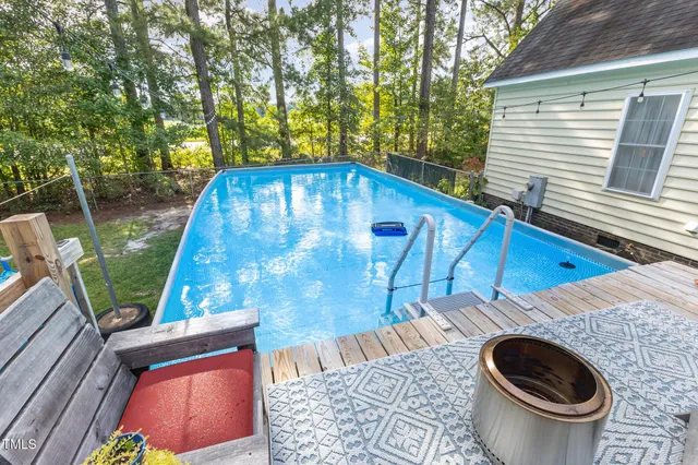 a view of a deck with two chair and wooden floor