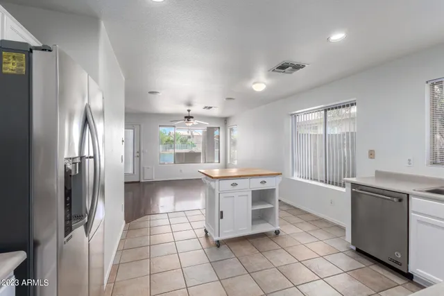 a kitchen with stainless steel appliances a refrigerator sink and cabinets
