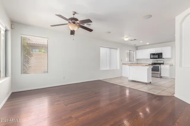 a view of empty room with wooden floor and window