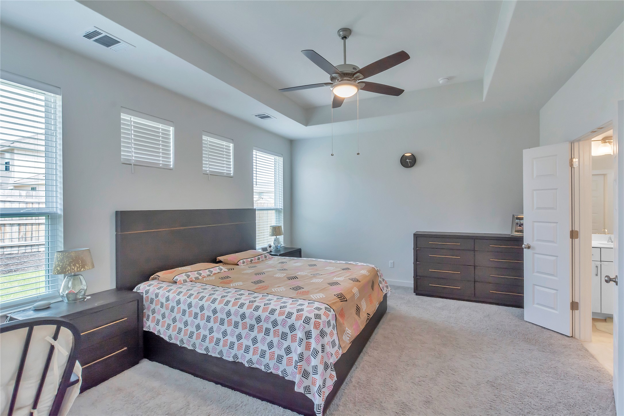 563 Saturnia Drive Georgetown, TX 78628 - Photo 12 of 29 a bedroom with a bed and a chandelier