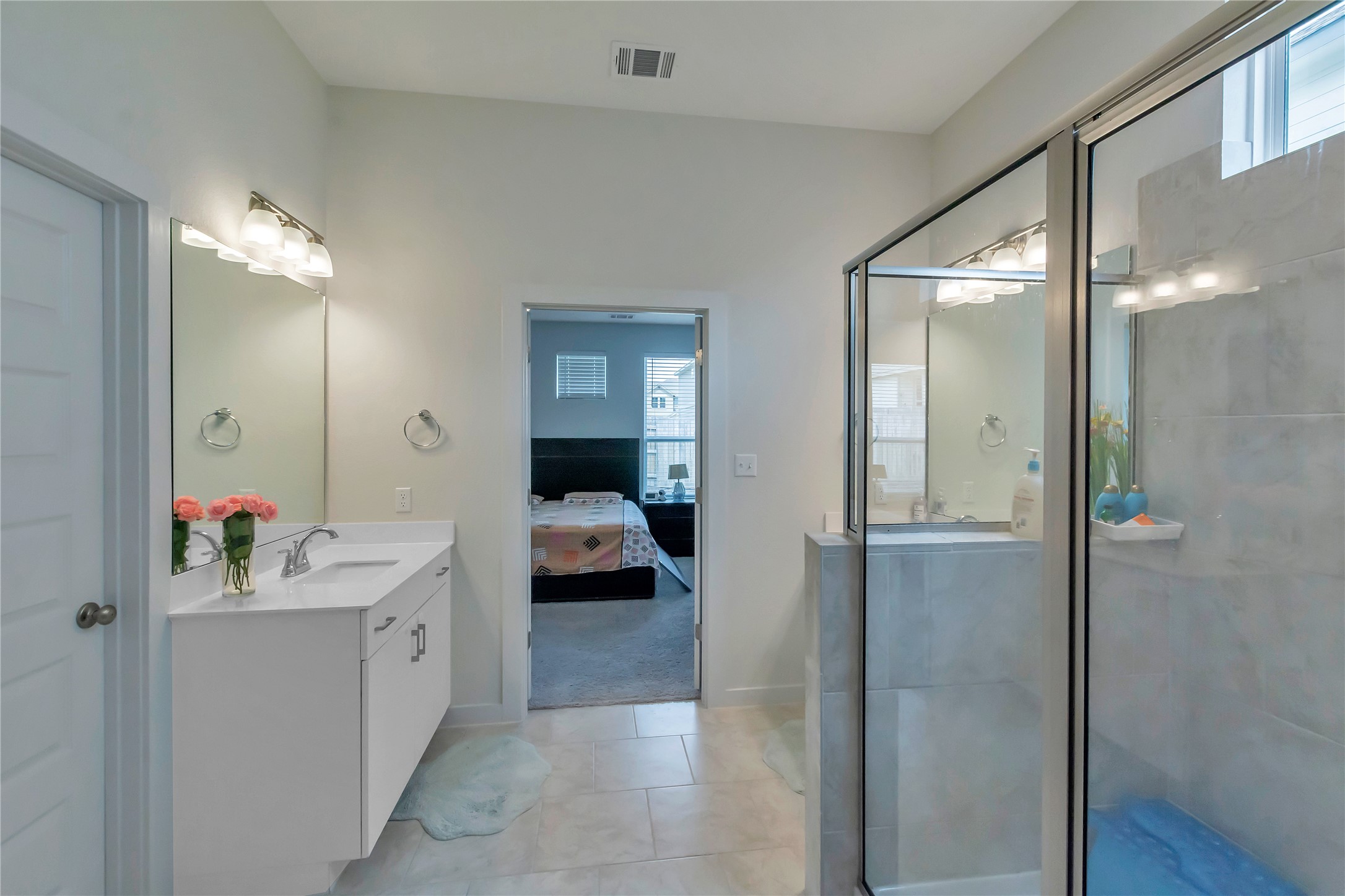 563 Saturnia Drive Georgetown, TX 78628 - Photo 22 of 29 a en suite bathroom with a sink mirror and shower