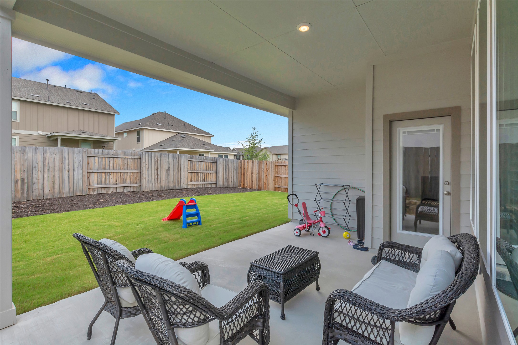 563 Saturnia Drive Georgetown, TX 78628 - Photo 28 of 29 a view of a chairs and table in patio with a yard