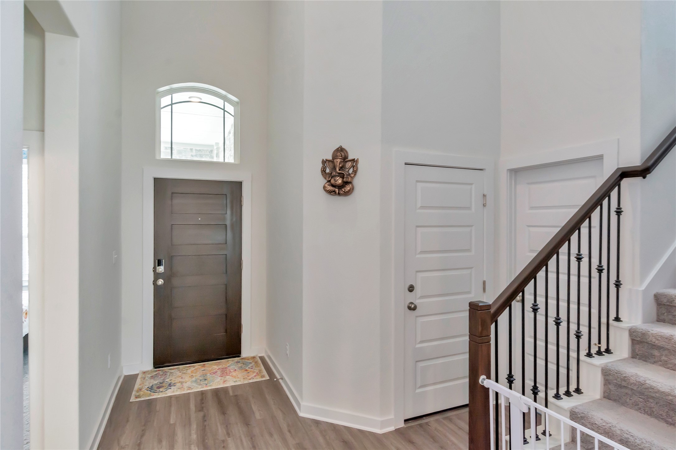 563 Saturnia Drive Georgetown, TX 78628 - Photo 5 of 29 a view of a hallway with wooden floor and staircase
