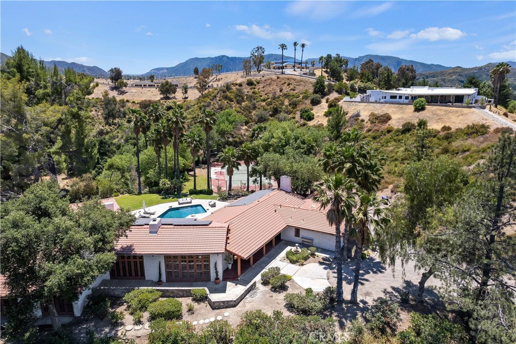 27444 Trail Ridge Road Canyon Country, CA 91387 - Photo 1 of 1 a view of a houses with a yard