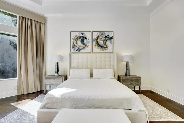 a spacious bedroom with a bed and a large window