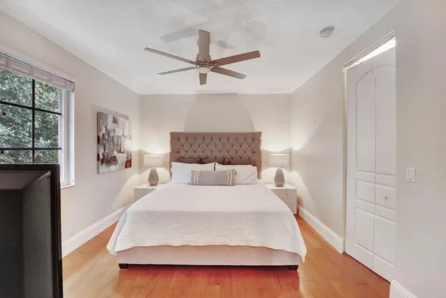 a bedroom with a bed and ceiling fan