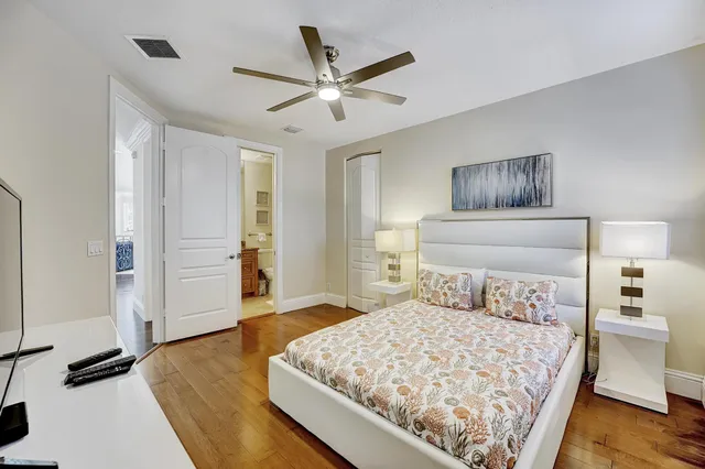 a bathroom with a granite countertop sink a toilet and shower