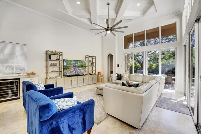 a living room with furniture fireplace and a large window
