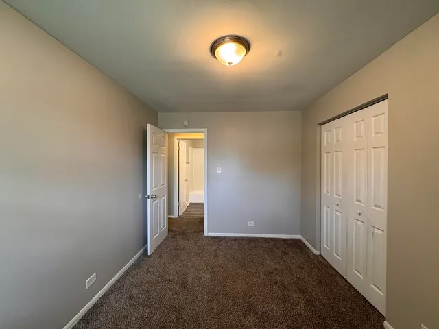 an empty room with windows and entrance