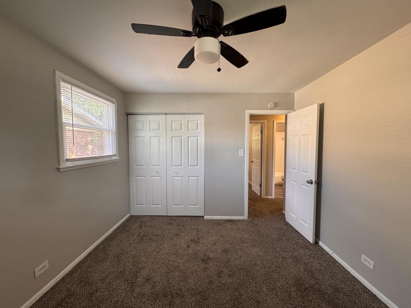3312 Maple Lane Hazel Crest, IL 60429 - Photo 18 of 27 an empty room with windows and fan