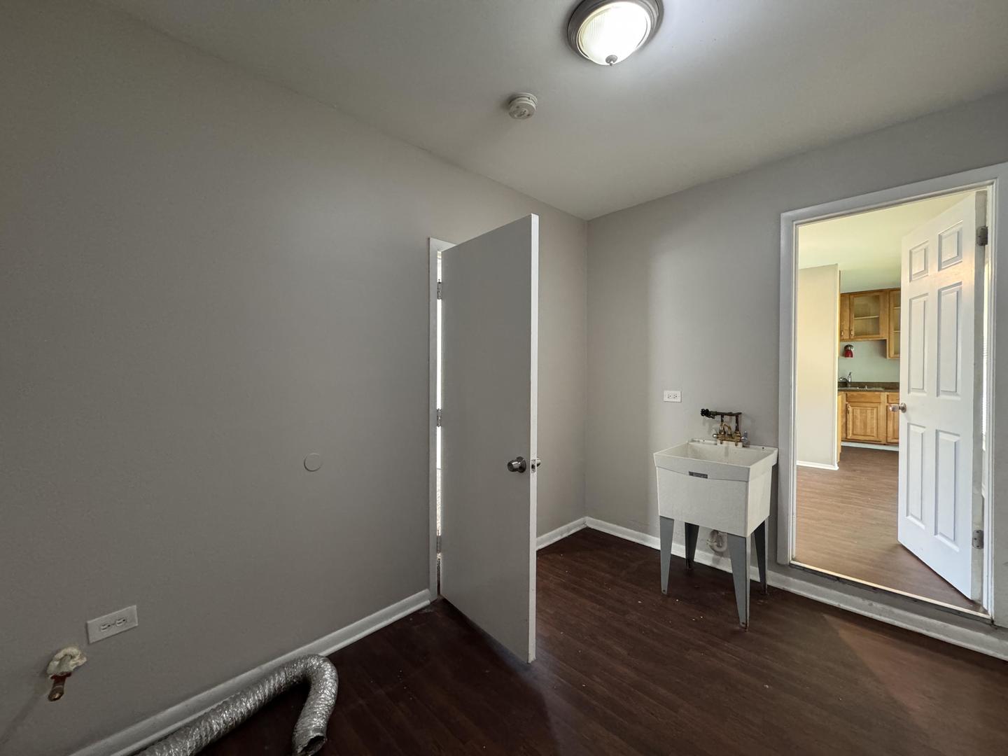 3312 Maple Lane Hazel Crest, IL 60429 - Photo 23 of 27 an empty room with wooden floor and windows