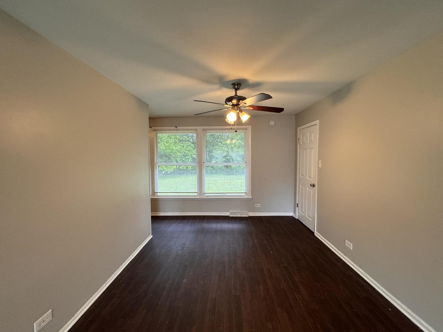 3312 Maple Lane Hazel Crest, IL 60429 - Photo 9 of 27 a view of an empty room with wooden floor and a window