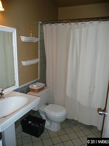 1810 Stardust Street Reno, NV 89503 - Photo 12 of 13 a bathroom with a granite countertop sink and a toilet