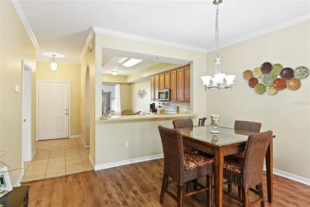 a view of a dining room and a kitchen with a table chairs