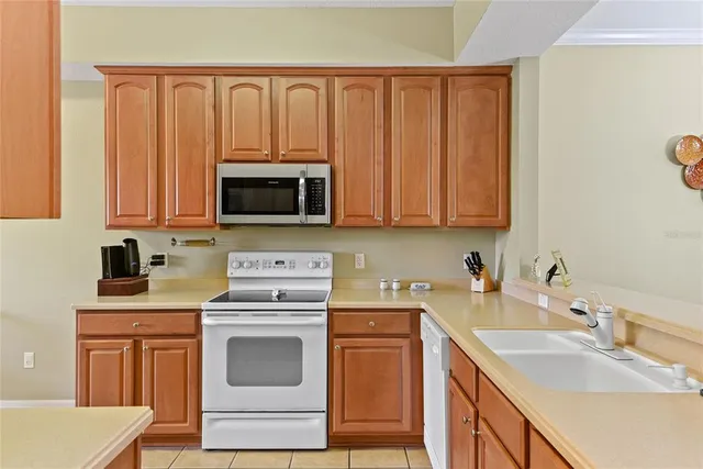 a kitchen with stainless steel appliances granite countertop a sink stove and microwave