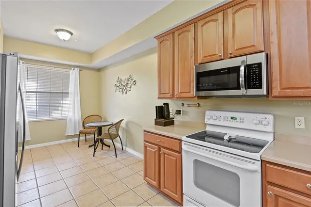 a kitchen with stainless steel appliances a stove a sink and a microwave