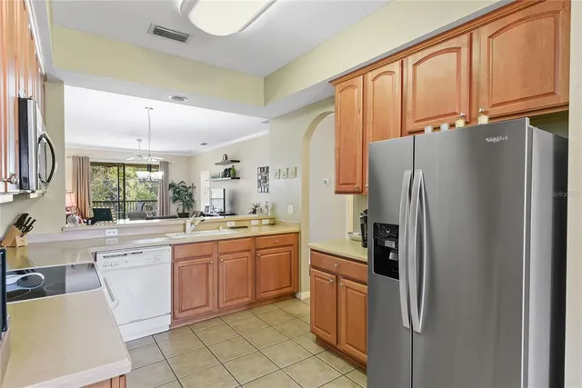 a kitchen with stainless steel appliances a refrigerator sink and cabinets