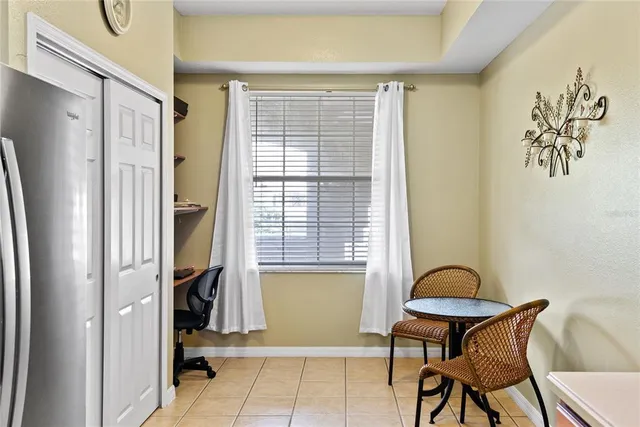 a view of a room that has a bed and a chair in it