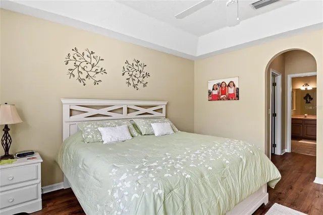 a bedroom with a bed and a painting on the wall