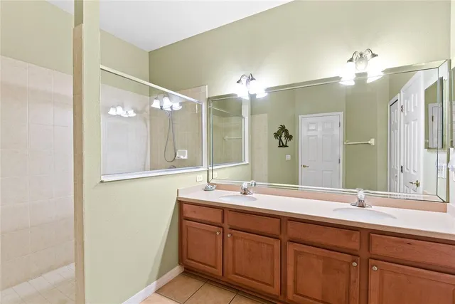 a bathroom with a double vanity sink and a mirror