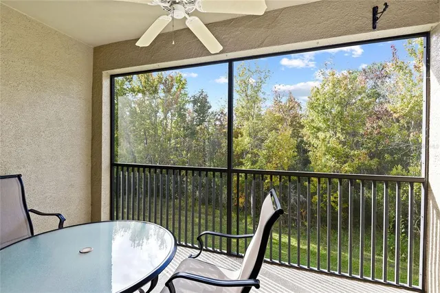 a view of a balcony with chair and wooden floor
