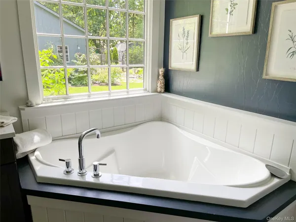 a bathroom with a bathtub and a window