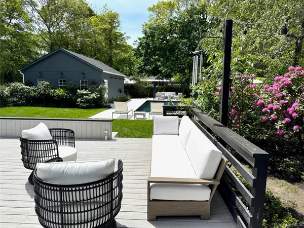 a view of a house with backyard sitting area and garden