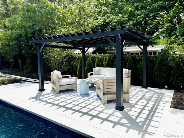 a view of swimming pool with seating space