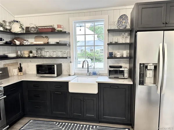 a kitchen with stainless steel appliances a sink and cabinets