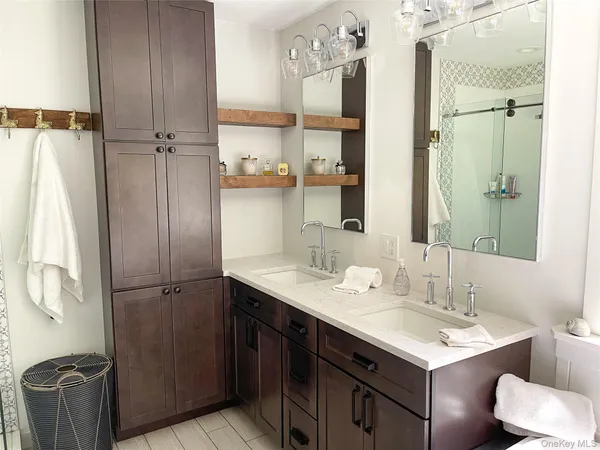 a bathroom with a sink vanity toilet and shower