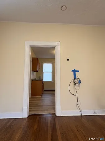a view of a room with wooden floor