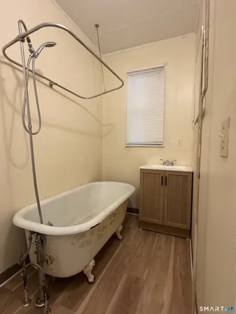 a bathroom with a sink a window and a shower