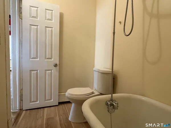 a bathroom with a granite countertop toilet and a sink