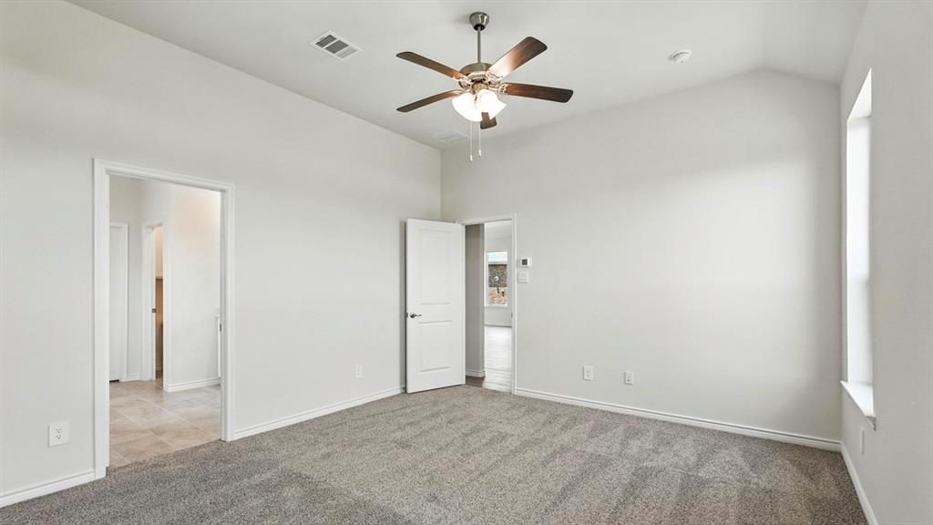 4191 Waldron Trail Forney, TX 75126 - Photo 14 of 20 Spacious interior room featuring vaulted ceilings and neutral gray carpeting