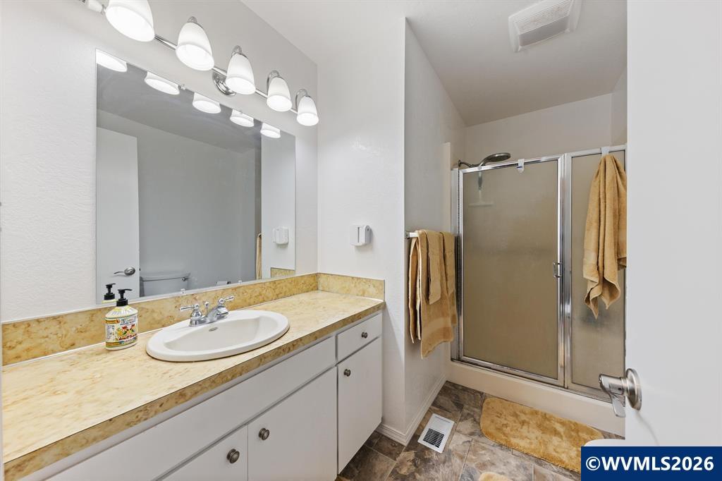 6100 Teal Creek Road Dallas, OR 97338 - Photo 15 of 41 a bathroom with a granite countertop sink a shower and a mirror