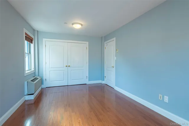 a view of wooden floor and windows in a room