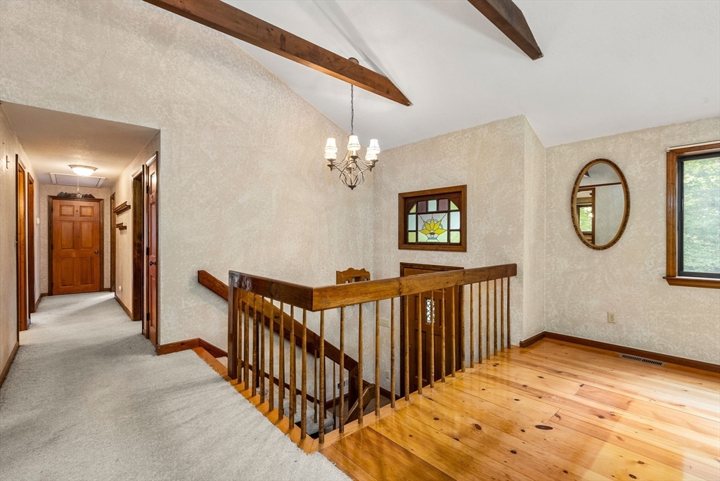 6 Jerry Road Sturbridge, MA 01566 - Photo 19 of 37 a view of a hallway with wooden floor and a chandelier