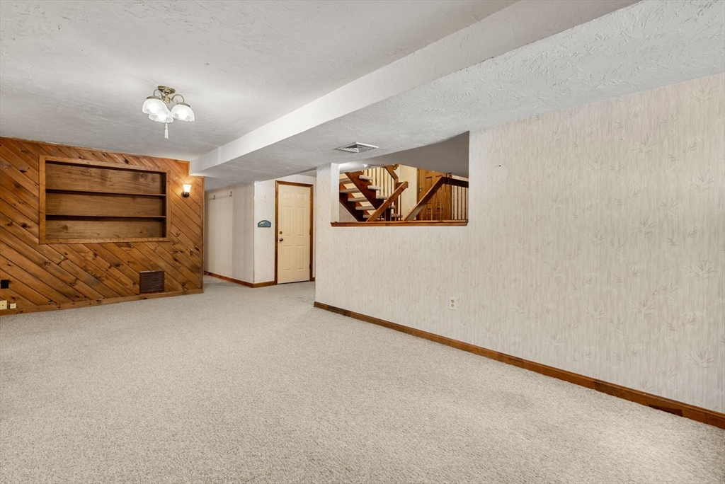 6 Jerry Road Sturbridge, MA 01566 - Photo 23 of 37 an empty room with chandelier and refrigerator