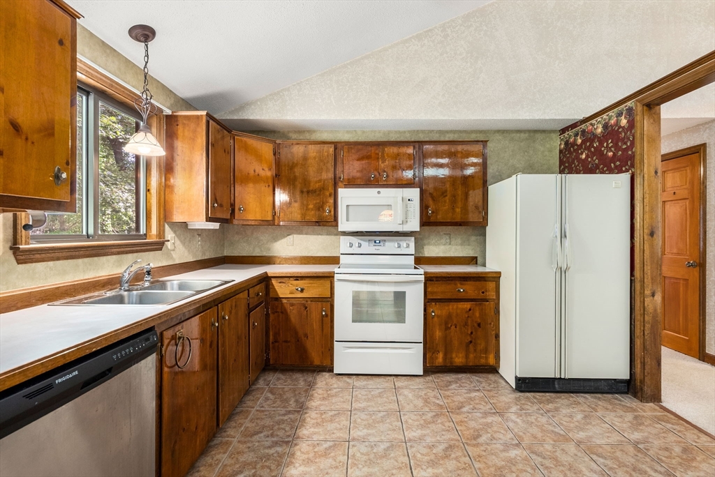 6 Jerry Road Sturbridge, MA 01566 - Photo 8 of 37 a kitchen with stainless steel appliances a refrigerator sink and stove