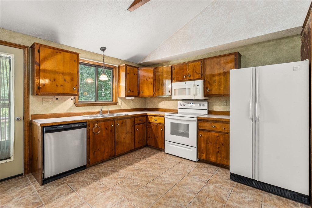 6 Jerry Road Sturbridge, MA 01566 - Photo 9 of 37 a kitchen with white cabinets and white appliances