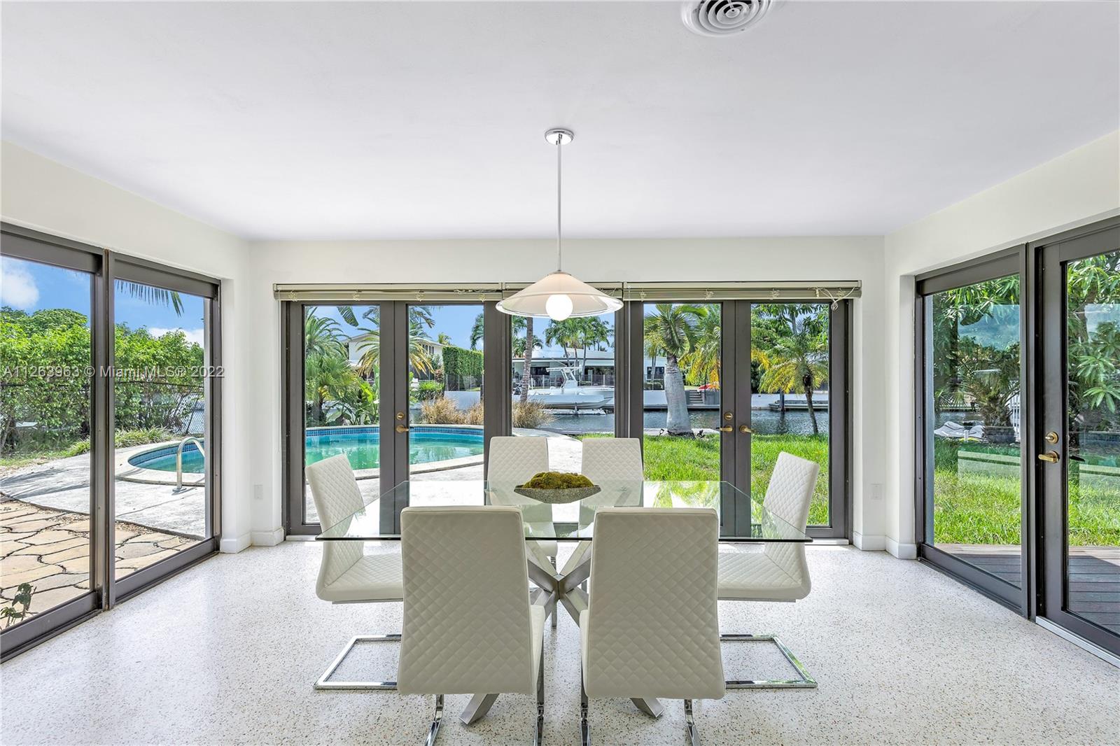 12906 Cherry Road North Miami, FL 33181 - Photo 8 of 20 a dining room with furniture large windows and wooden floor