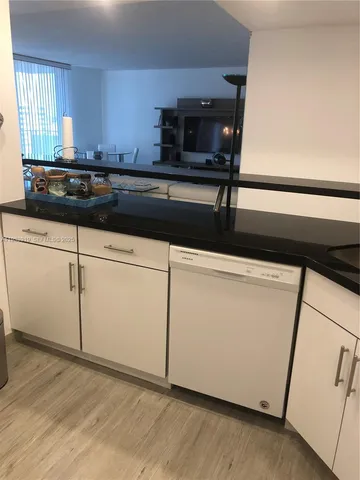 a kitchen with sink cabinets and wooden floor