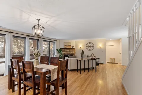 a view of a dining room with furniture window and wooden floor
