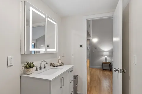a bathroom with a sink vanity and a mirror