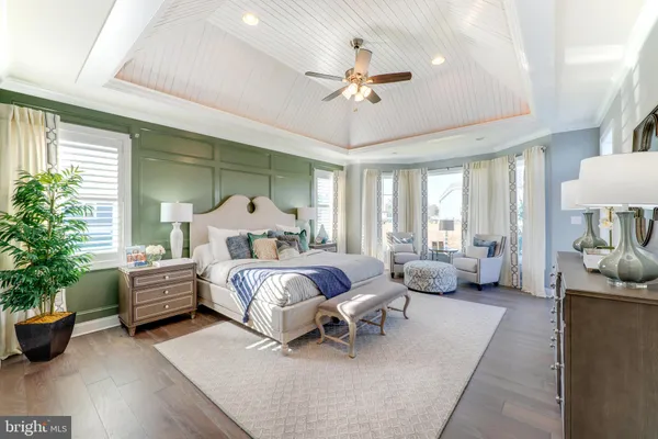 a spacious bedroom with a balcony a bed and a chandelier