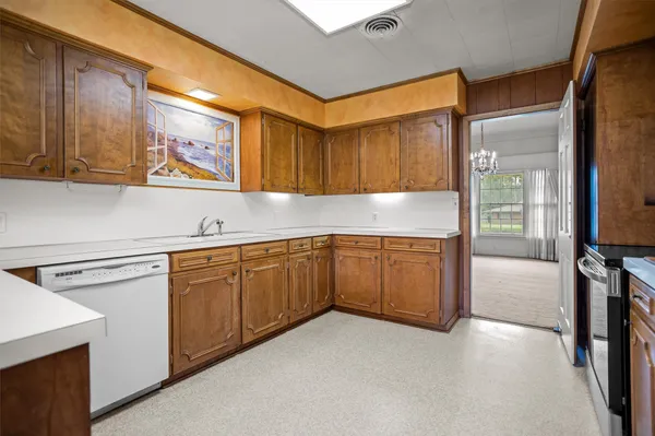 a kitchen with granite countertop a sink and cabinets
